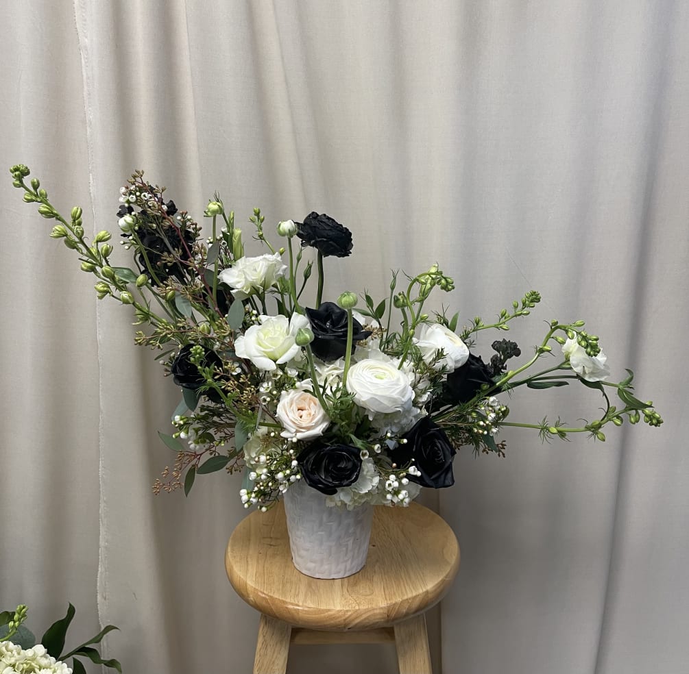 Mixed white and sprayed black carnations, roses and ranaculus 
