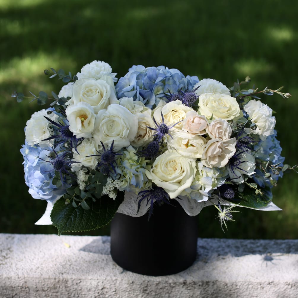 This bouquet in a box is a stunning arrangement featuring white roses