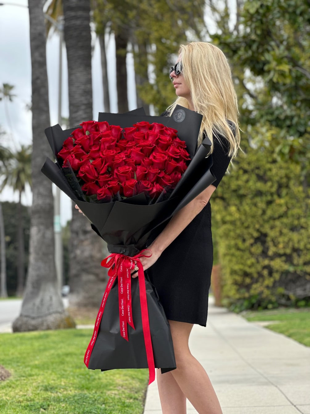 Our exclusive bouquet of red along stem roses arranged in the shape