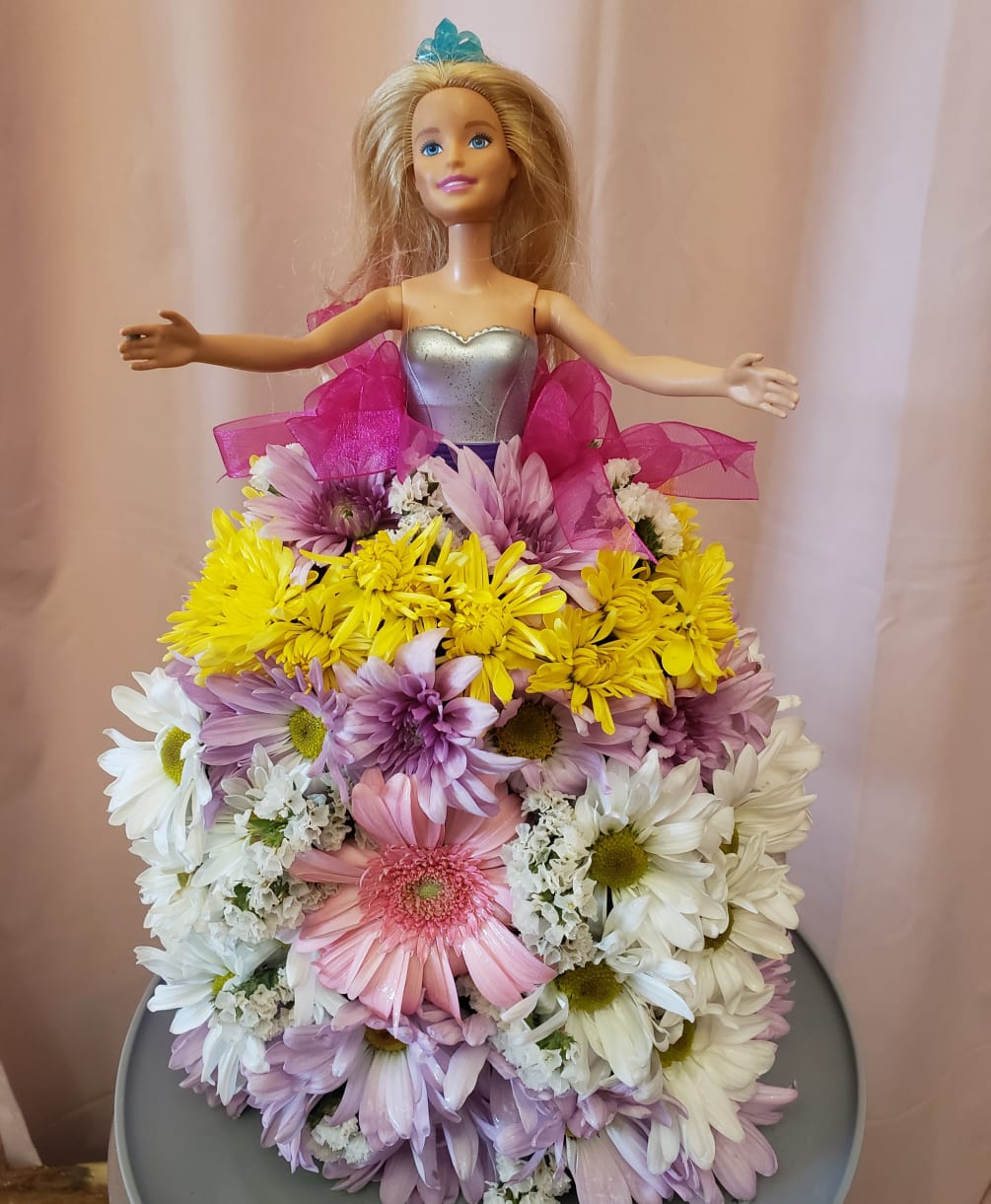 Come on Barbie, lets go party! This adorable Barbie floral arrangement is