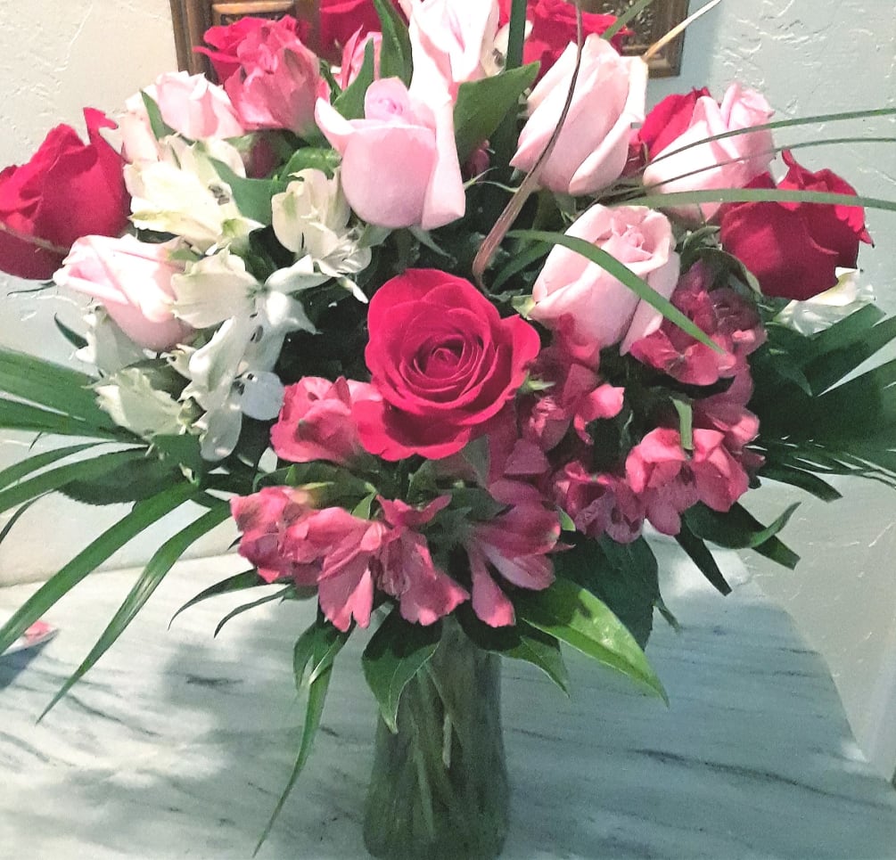 Fresh floral arrangement with roses and peruvian lilies. We deliver!
