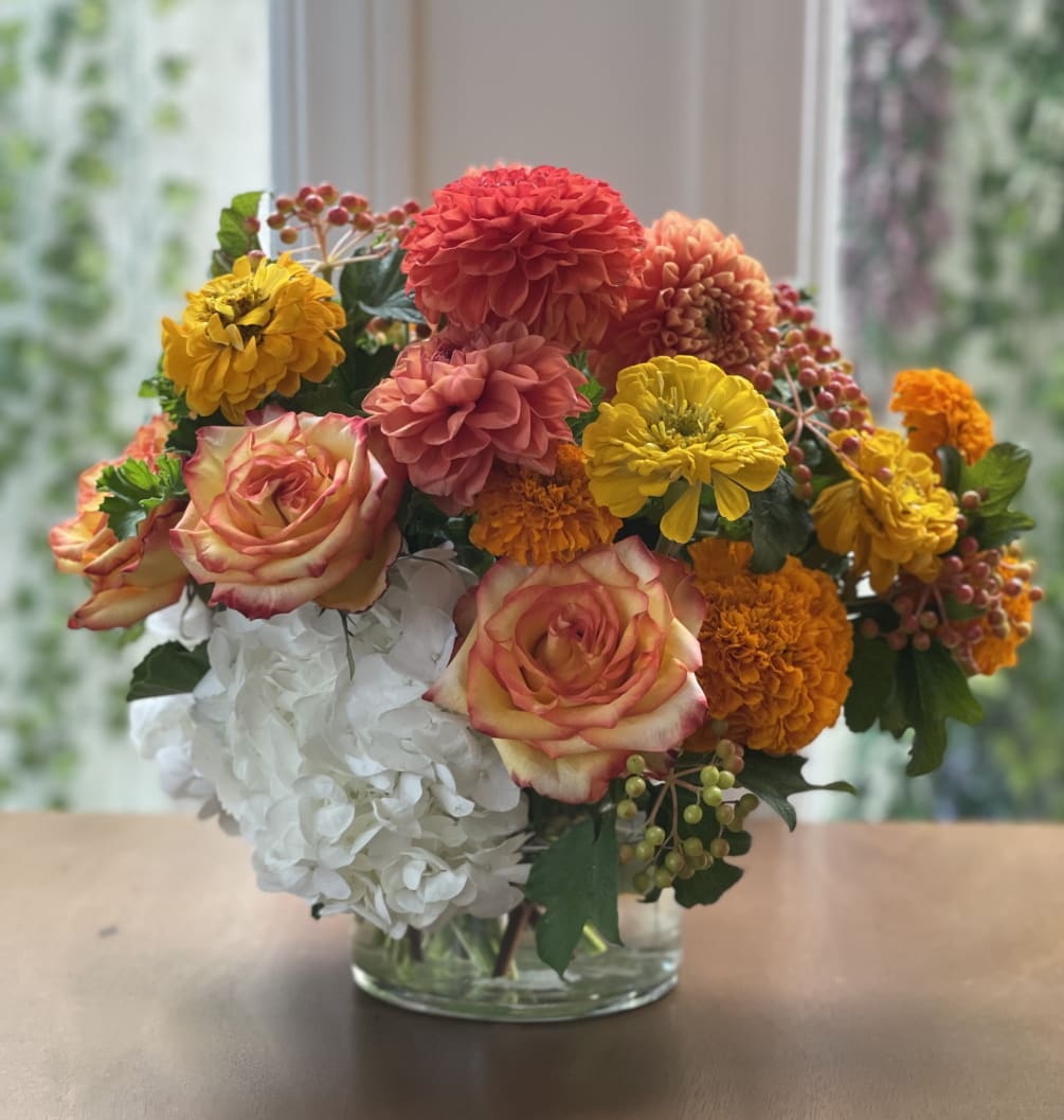 This bright, lovely smelling design has gorgeous dahlias and zinnias and orange