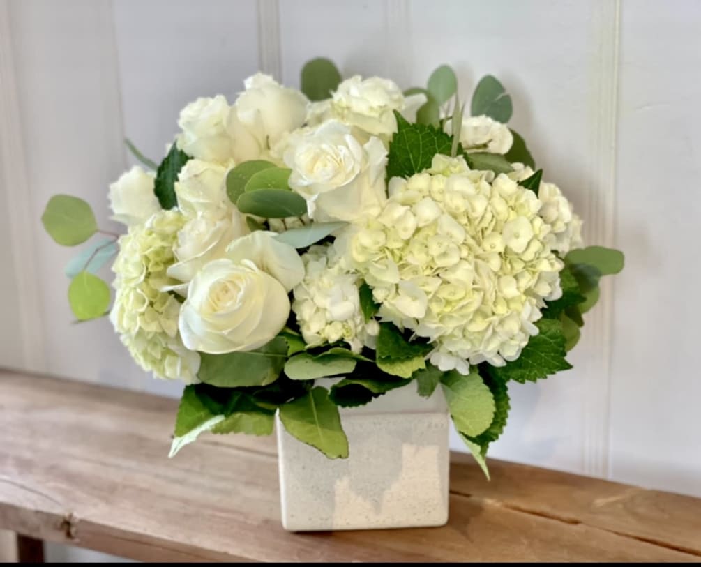 A very pretty all white arrangement with the finest white roses you