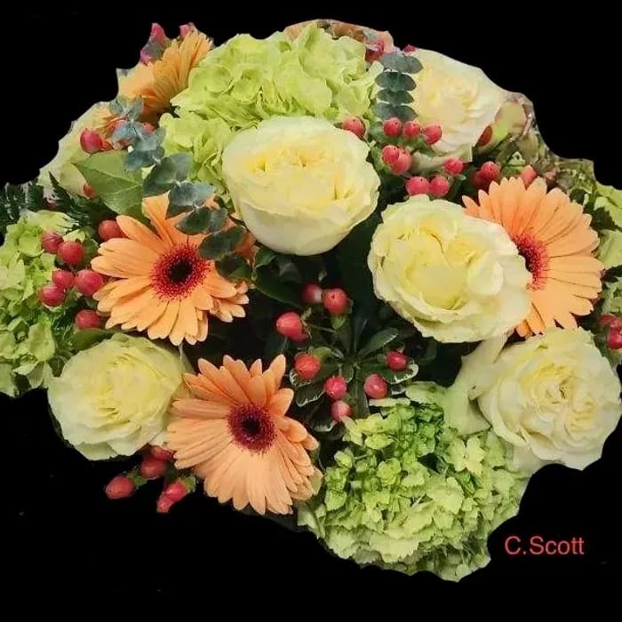 Mesmerizing Mojito hydrangea accented with Gerbera daisies, berries, roses and more will