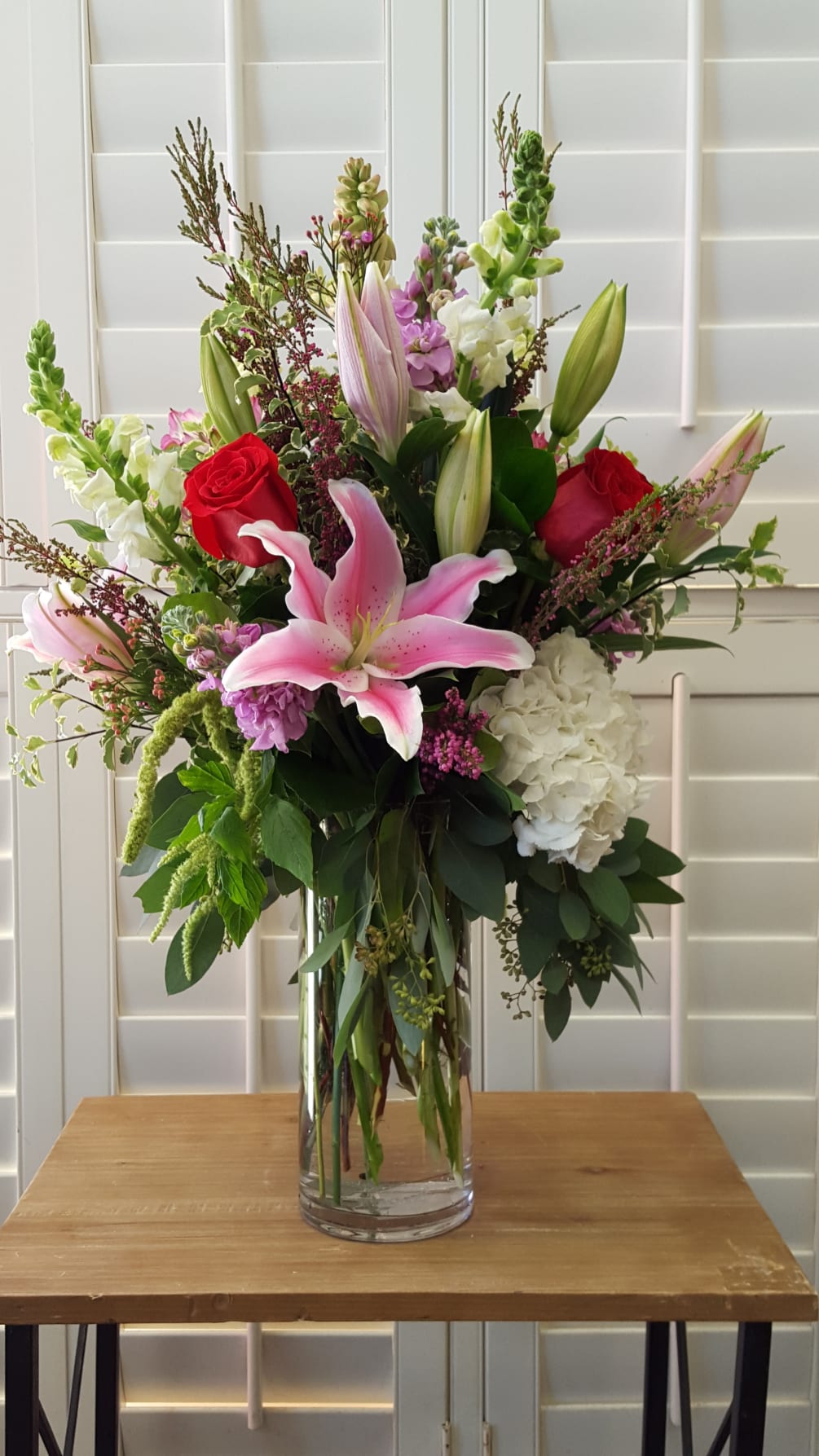 This beautiful vase arrangement is lush and filled of roses, hydrangea, lilies