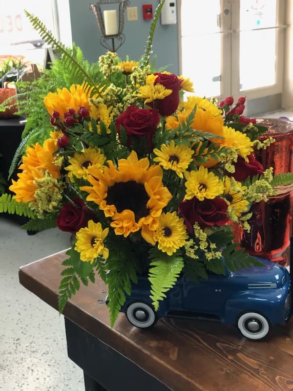 Ford truck with sunflowers and red roses