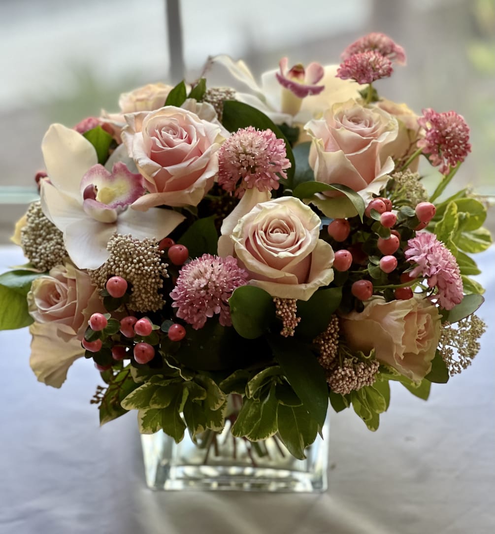 Charming and graceful arrangement with different shades of pink roses, rice flower