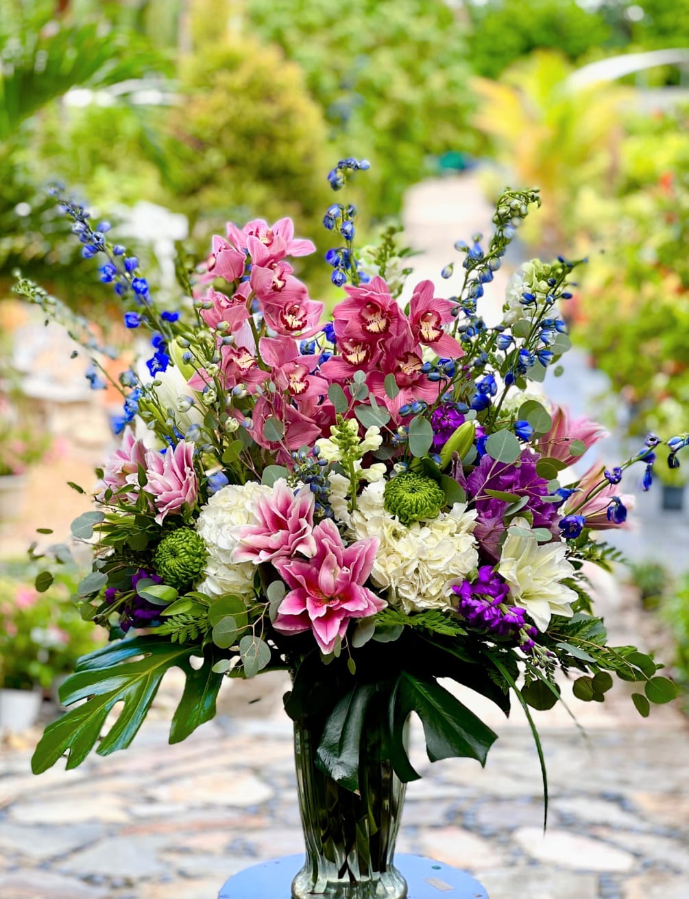 This stunning mix of hydrangea, rose lilies &amp; cymbidium orchids is guaranteed