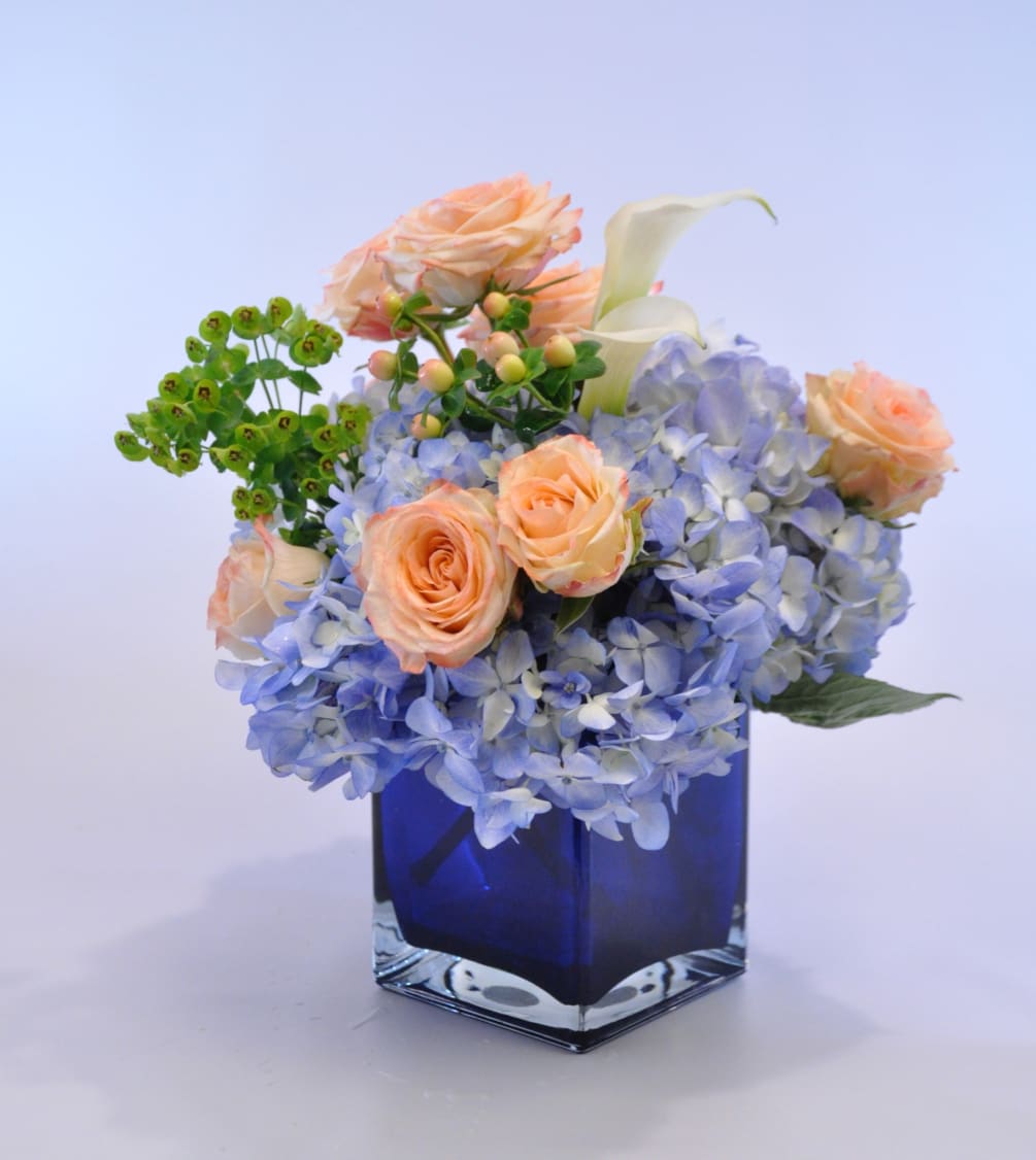 Soft and soothing, hydrangea, mini calla lilies and spray roses fill a