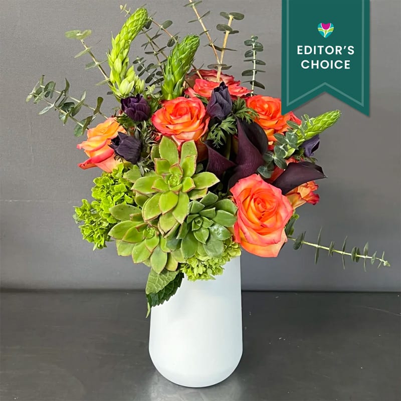 This beautiful arrangement has imported Ecuadorian roses, succulents, and mixed seasonal flowers.