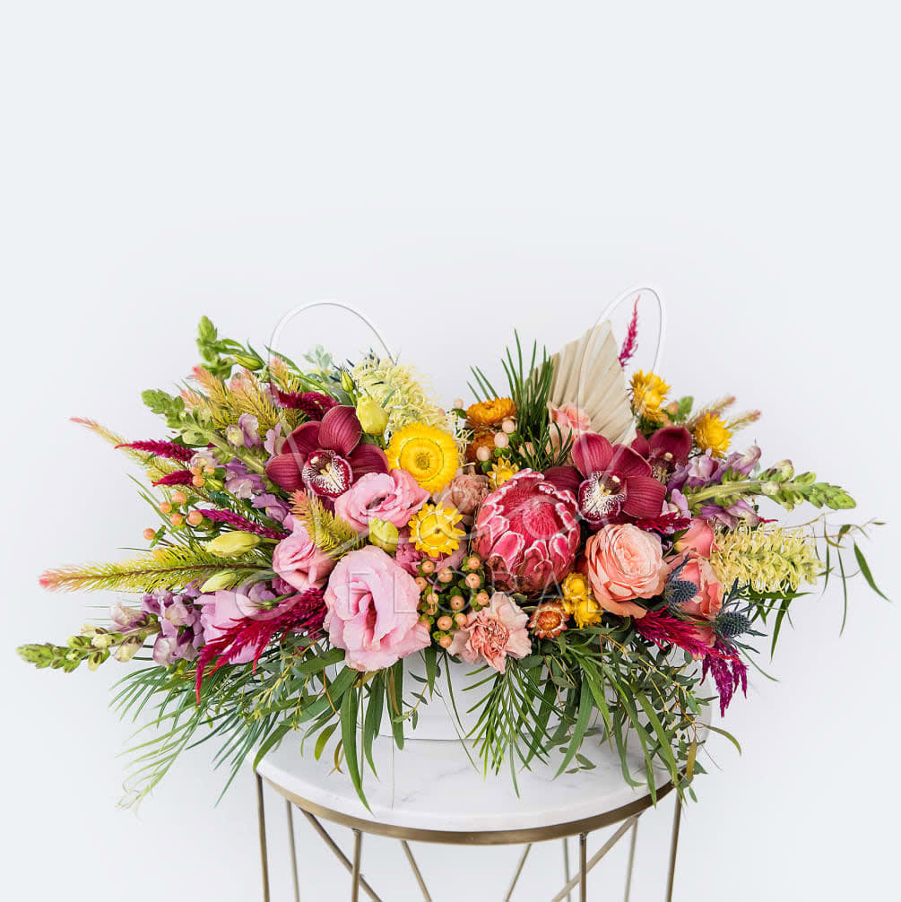 Our long and low arrangement features the best florals the season has