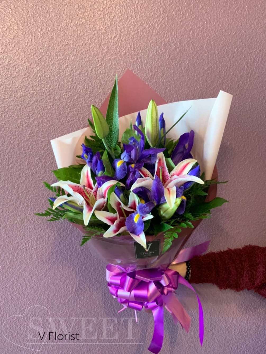 Six iris join with star fighter lilies  in a simple wrapped