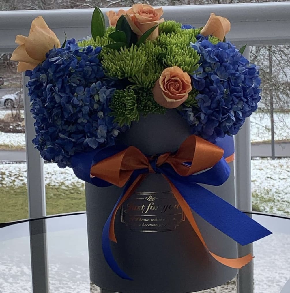 A blue and orange arrangement in a stylish grey box, this arrangement