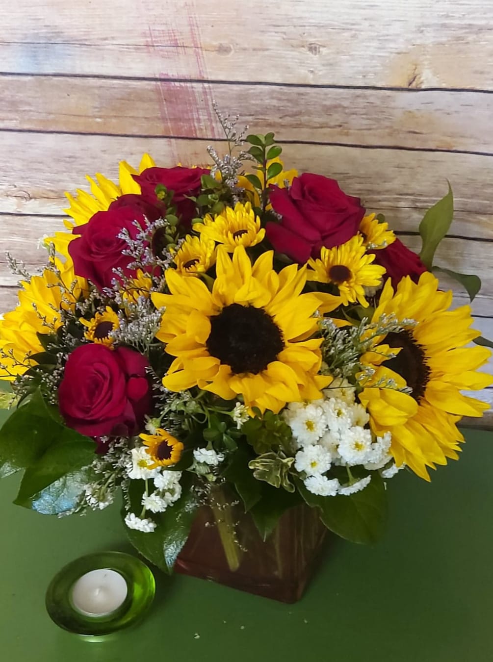 There&#039;s nothing like a mound of sunflowers, roses and spray roses designed