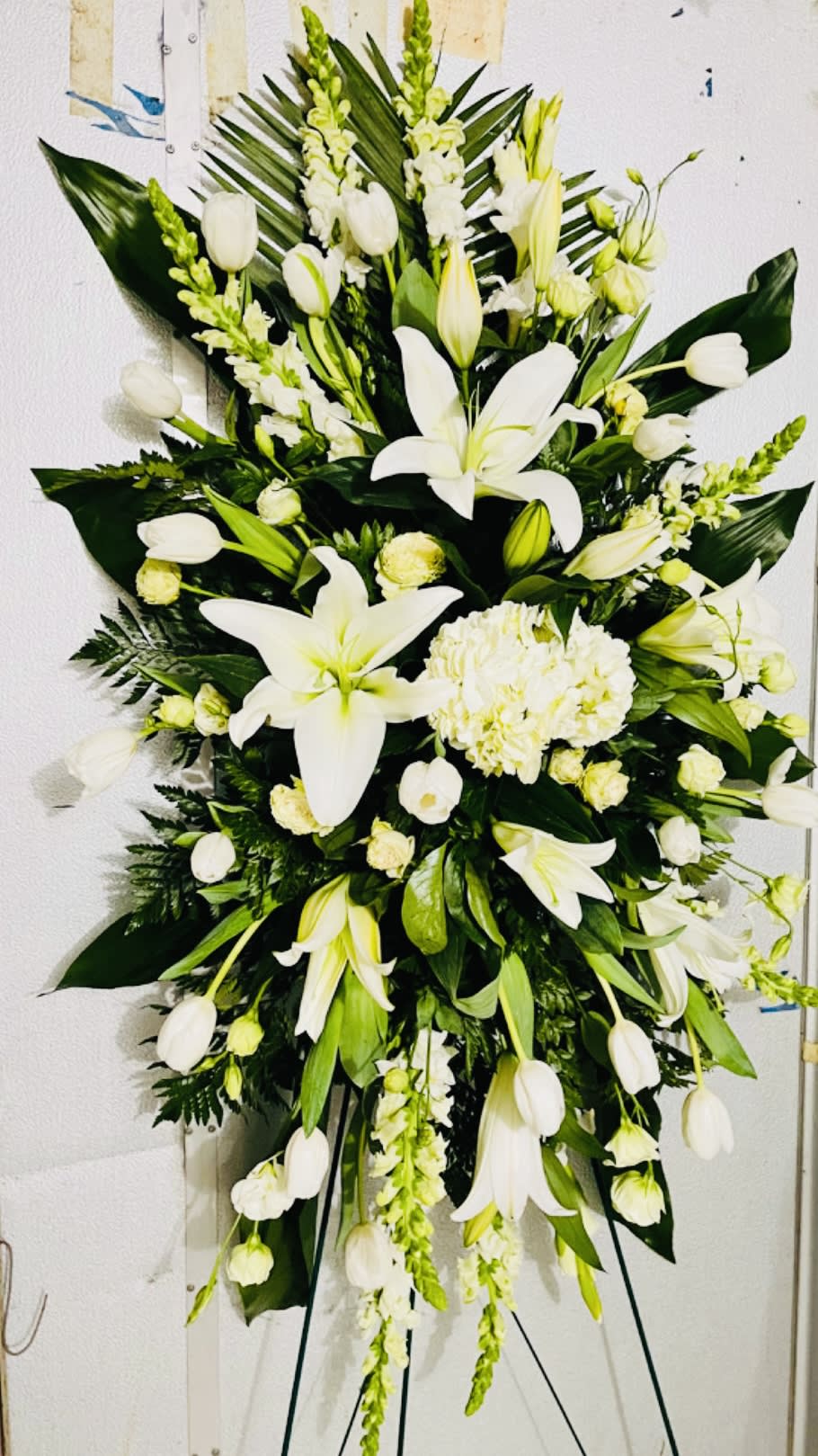 Beautiful primary white color with green accents, an elegant standing spray to