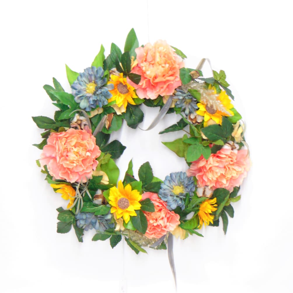 Peach and yellow silk wreath on grapevine base. 16&quot; diameter.