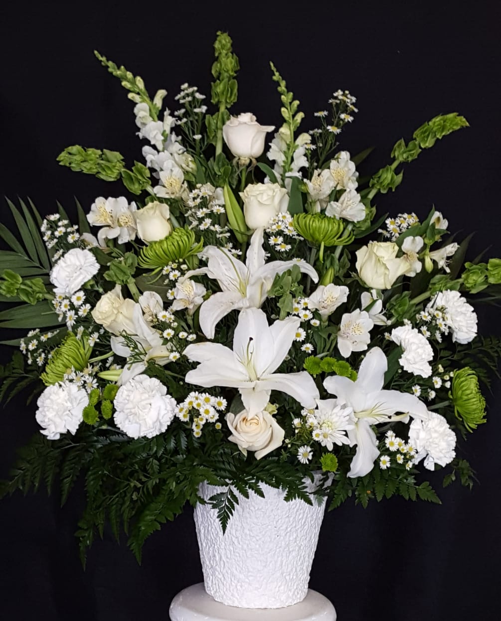 elegant white arrangement with green accents in a mache basket