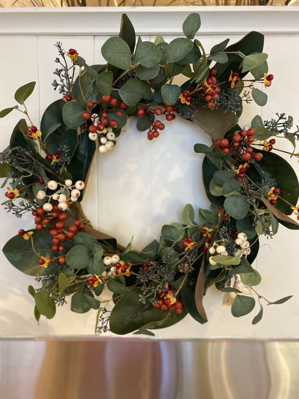 This beautiful artificial eucalyptose and rust and white berry wreath is roughly
