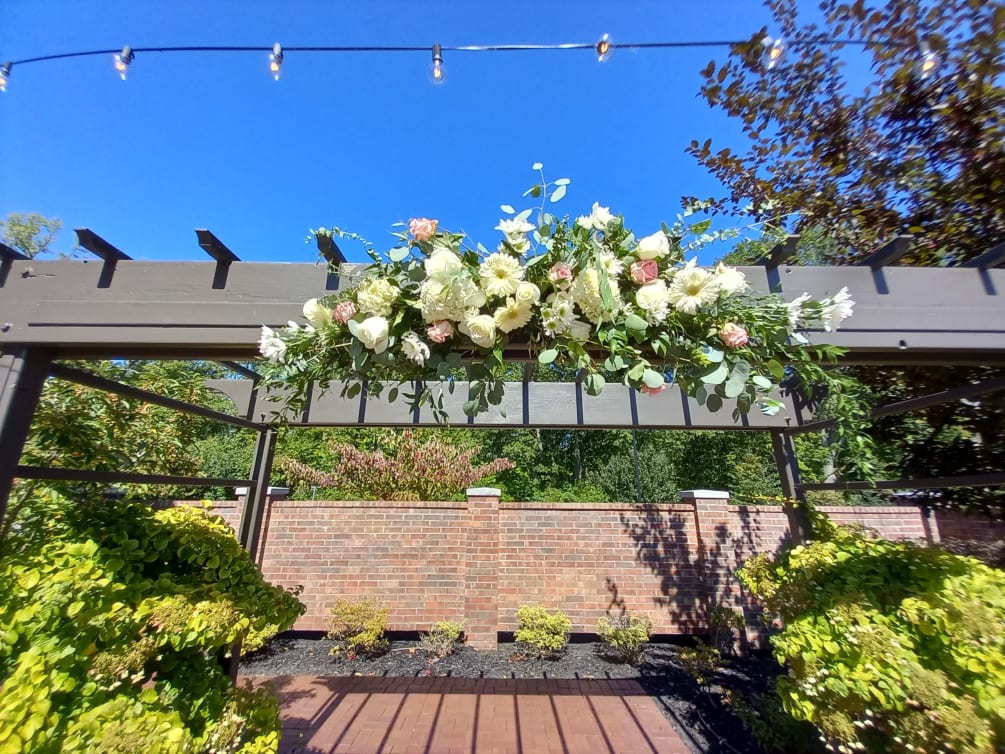 Beautiful Light colors white and pink roses, carnations, daisies and greens gazebo