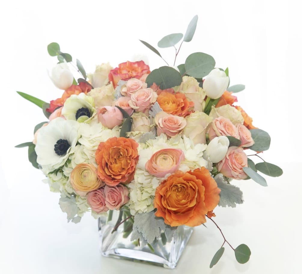 Peach and whites in a classic white vase. Rose, hydrangea, eucalyptus are