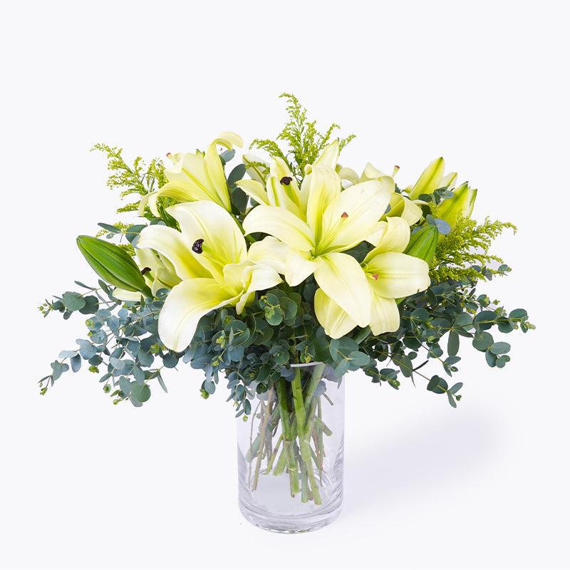 Floral composition of white lilies symbolize purity and innocence.
