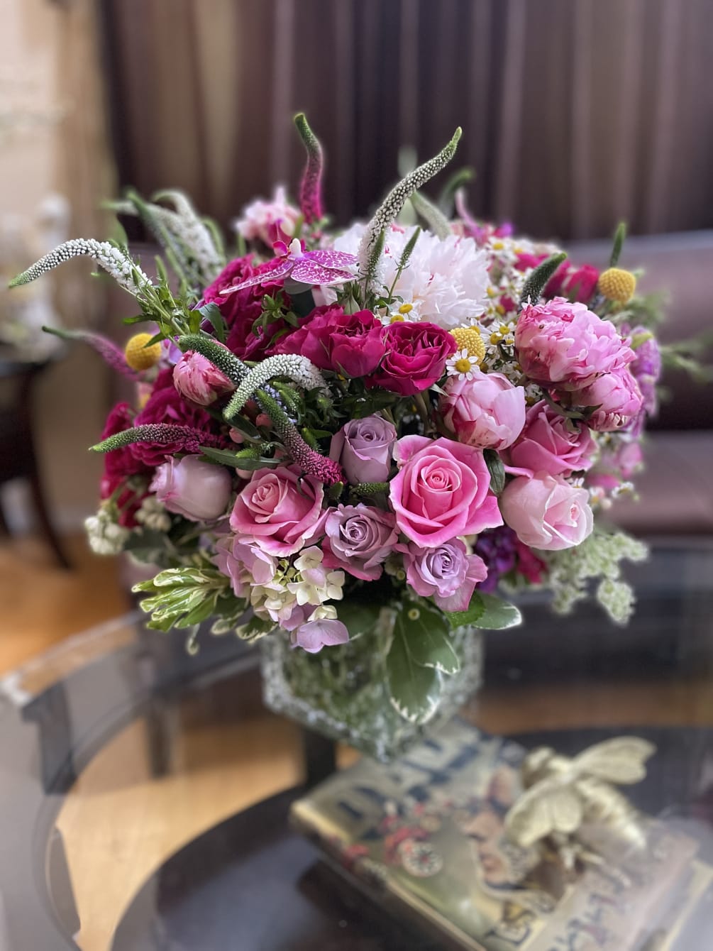 This exquisite floral arrangement combines the delicate beauty of pink roses with