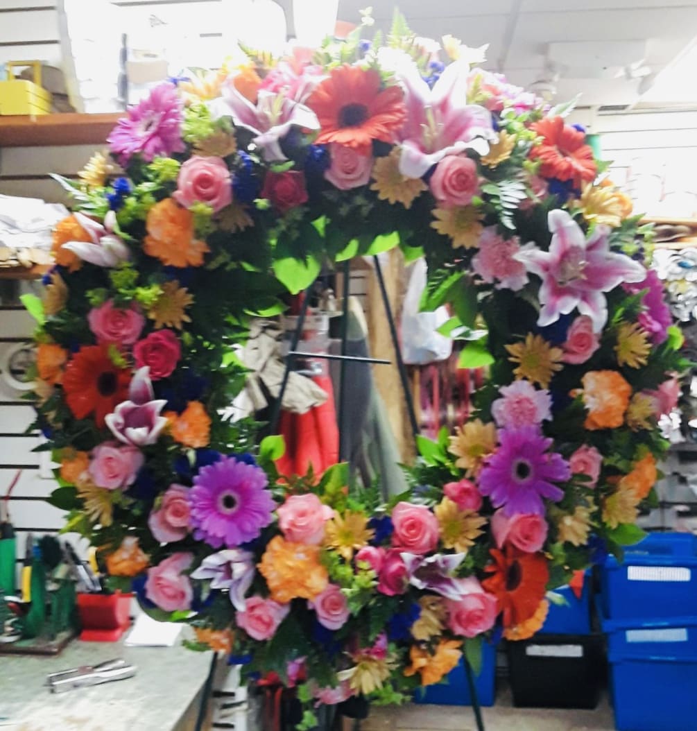 This colorful and bright wreath spray is representative of a life lived