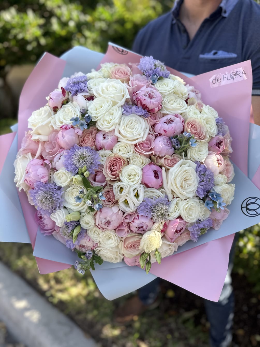 Large bouquet of peonies, roses, spray roses, lisianthus in pink and blue
