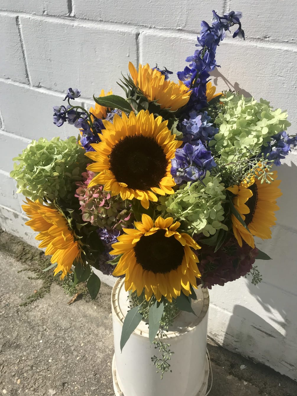 Vase arrangement with yellows blues and mixed colors 