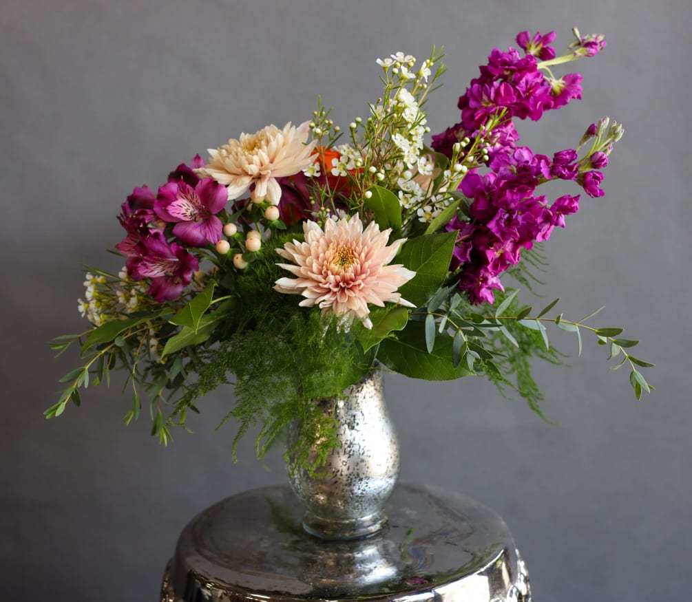 An elegant arrangement in a speckled silver vase designed with beauty and
