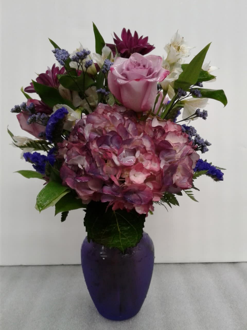 An arrangement of purple and white flowers mixed together in a beautiful