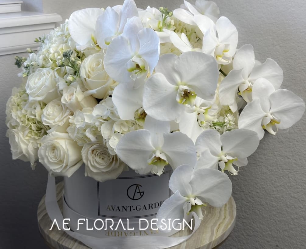 Premium white roses and beautiful orchids in our Luxurious Hat box. This