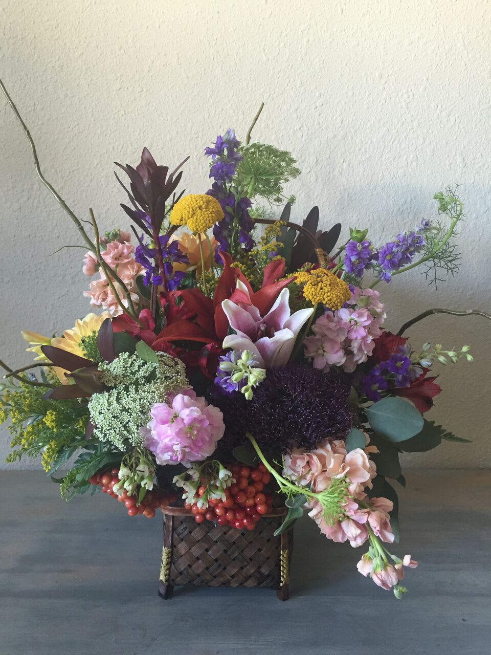 Mixture of garden flowers in cute basket.  