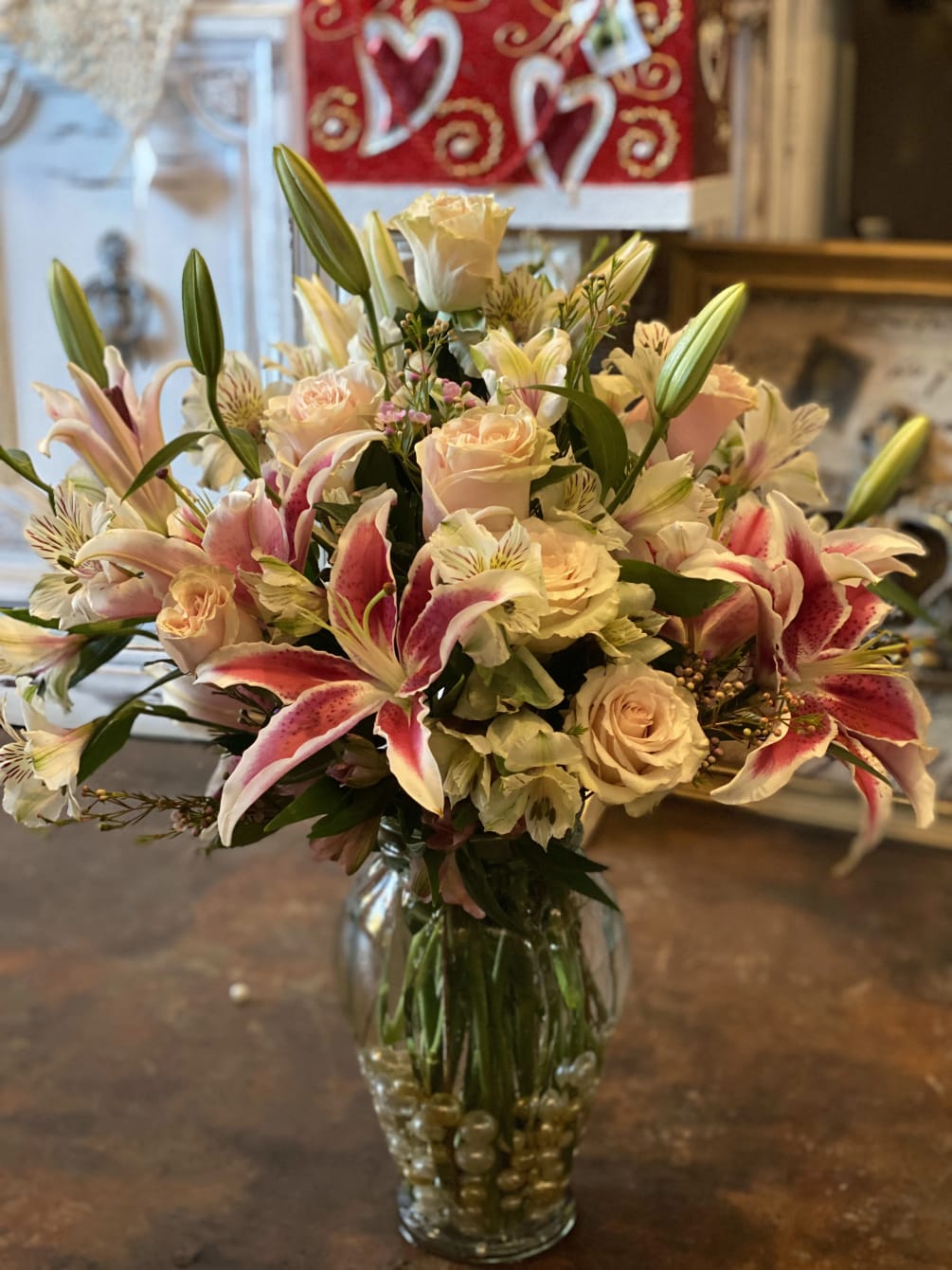 This romantic arrangement of stargazer lilies and pink roses will help to