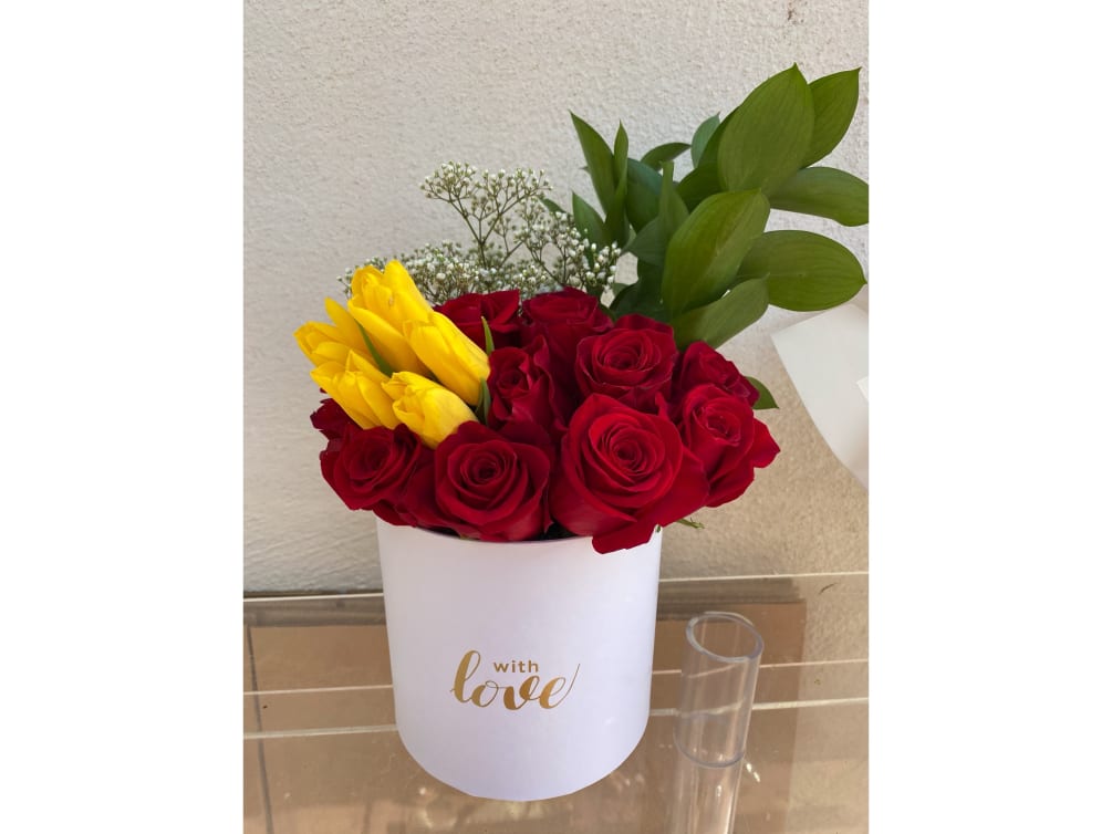 Red roses with yellow tulips and greens to give it that perfect