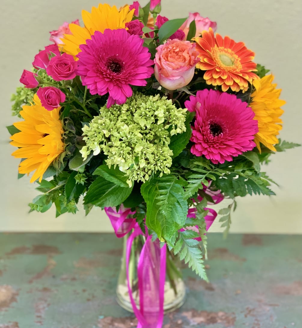 A happy combination of hydrangea, sunflowers, gerbera daises, mini spray roses and