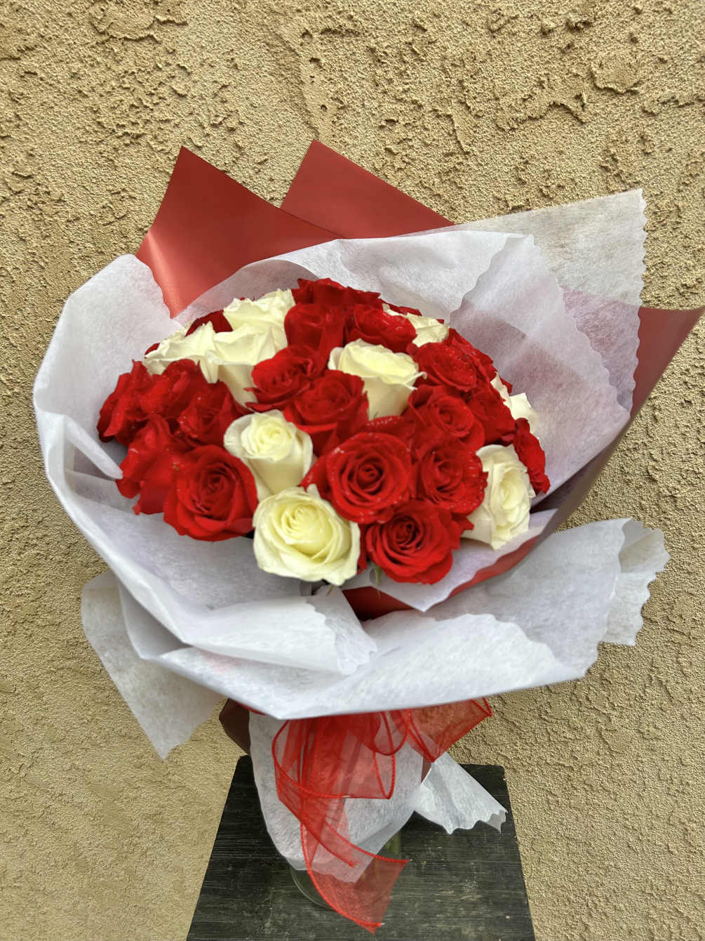 Beautiful arrangement featuring red and white roses. 