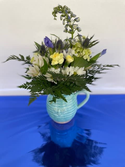Mixed arrangement in a purple bee vase.