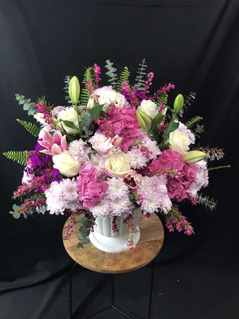 This bountiful arrangement is full of soft tones of pink and white