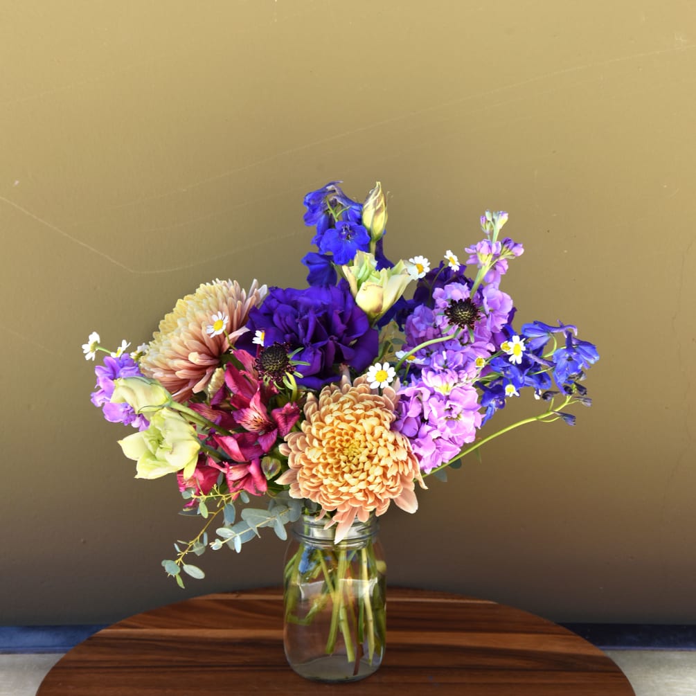 An arrangement that is reminiscent of a California summer afternoon. Featuring seasonal