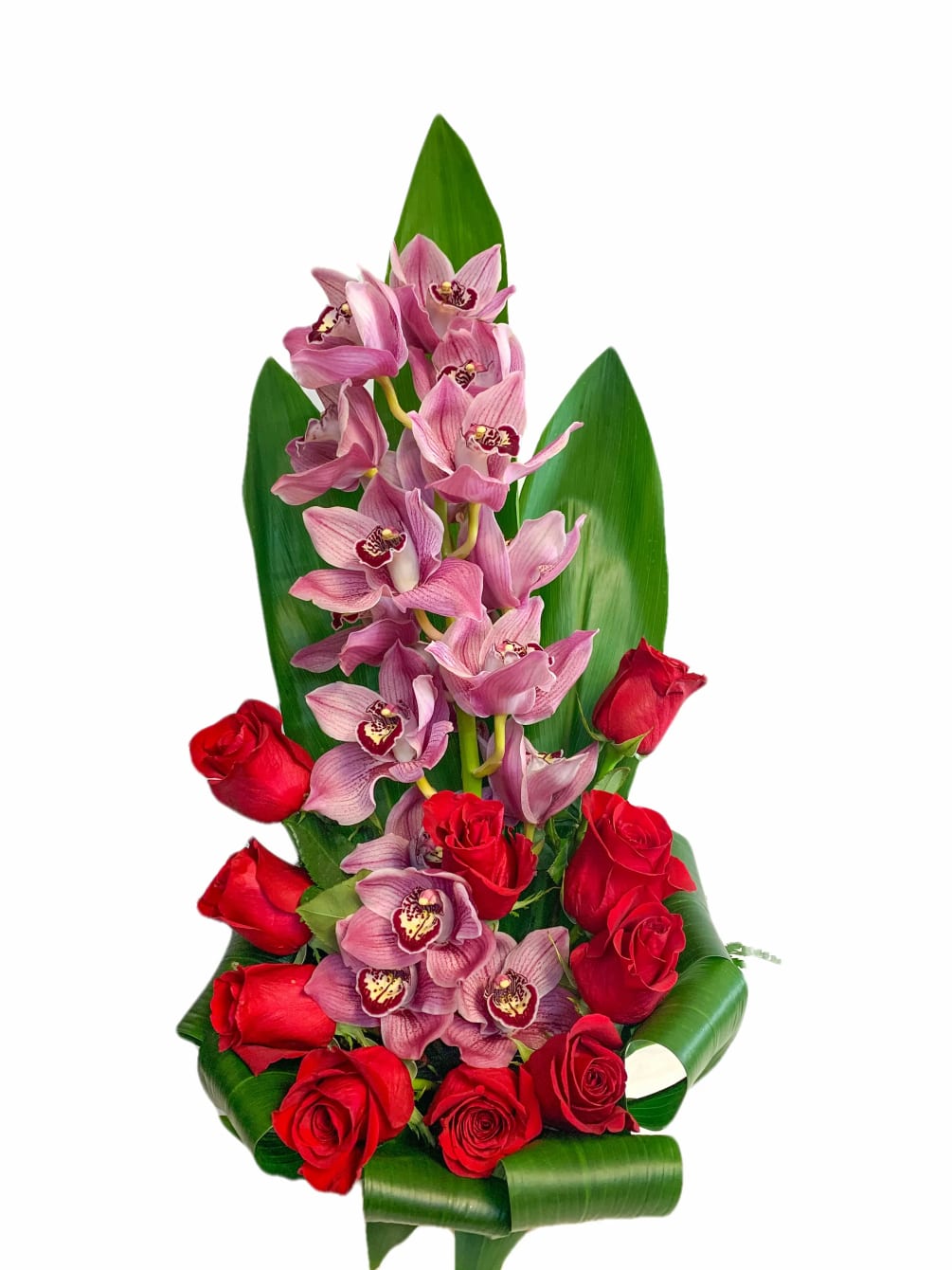 A luxurious exotic arrangement that has orchids and roses.