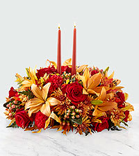 Our FTD Bright Autumn Centerpiece includes orange lilies; red roses; peach hypericum