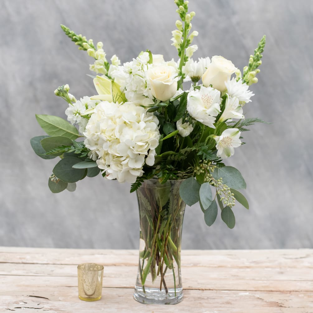 A distinguished all white arrangement perfect for every occasion, from celebrating an