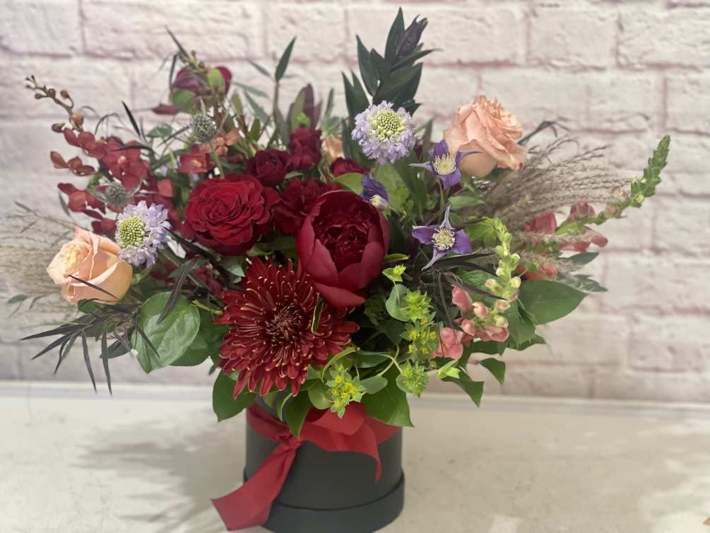 A large garden style bouquet of rich hues makes a grand display.