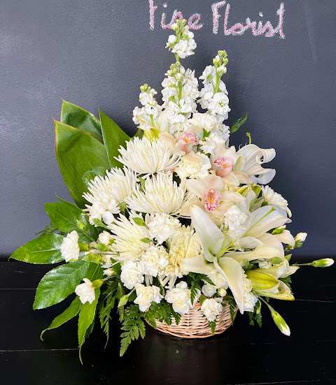 This beautiful arrangement offers a mix of chrysanthemums, cymbidium orchids and lilies.