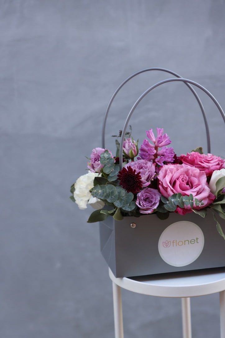 A bouquet of flowers in a craft bag is a rustic and