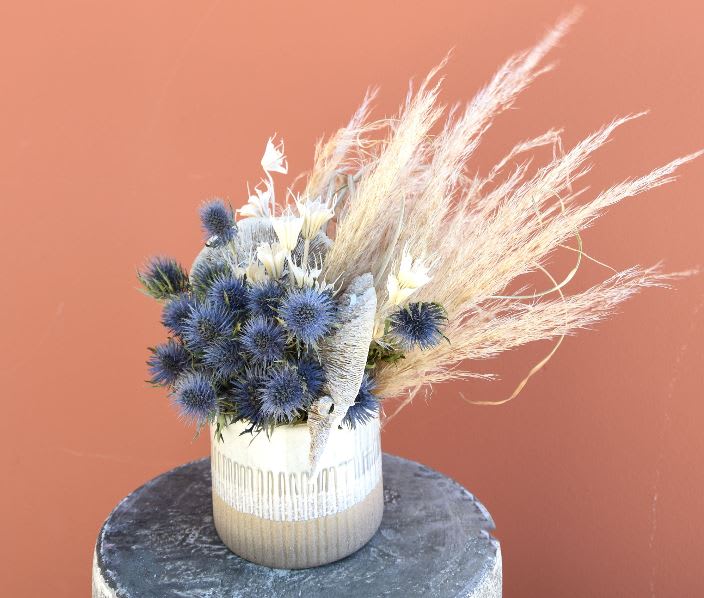 Featuring blue globe thistle, Polly is a burst of neutral preserved elements