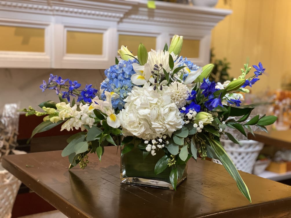 A blossom-filled imagination created with blue and white hydrangeas, asiatic lily, delphinium