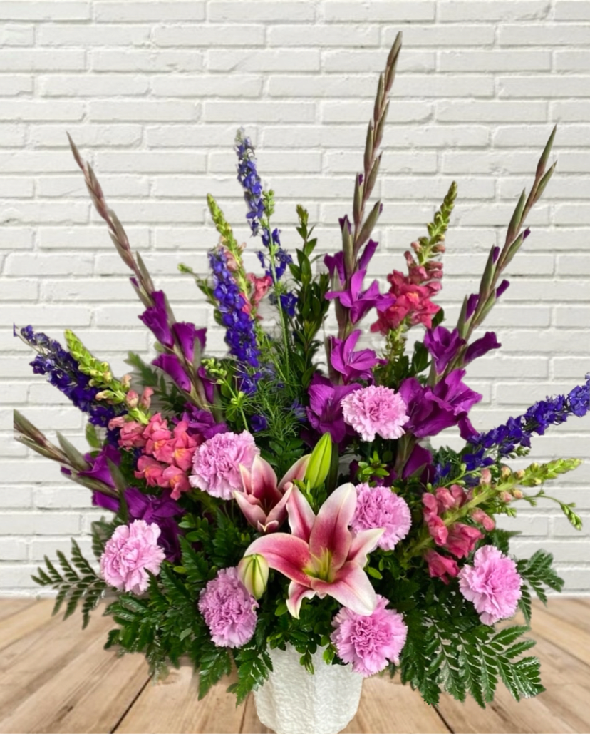 Purples &amp; Pinks in this one sided funeral arrangement.