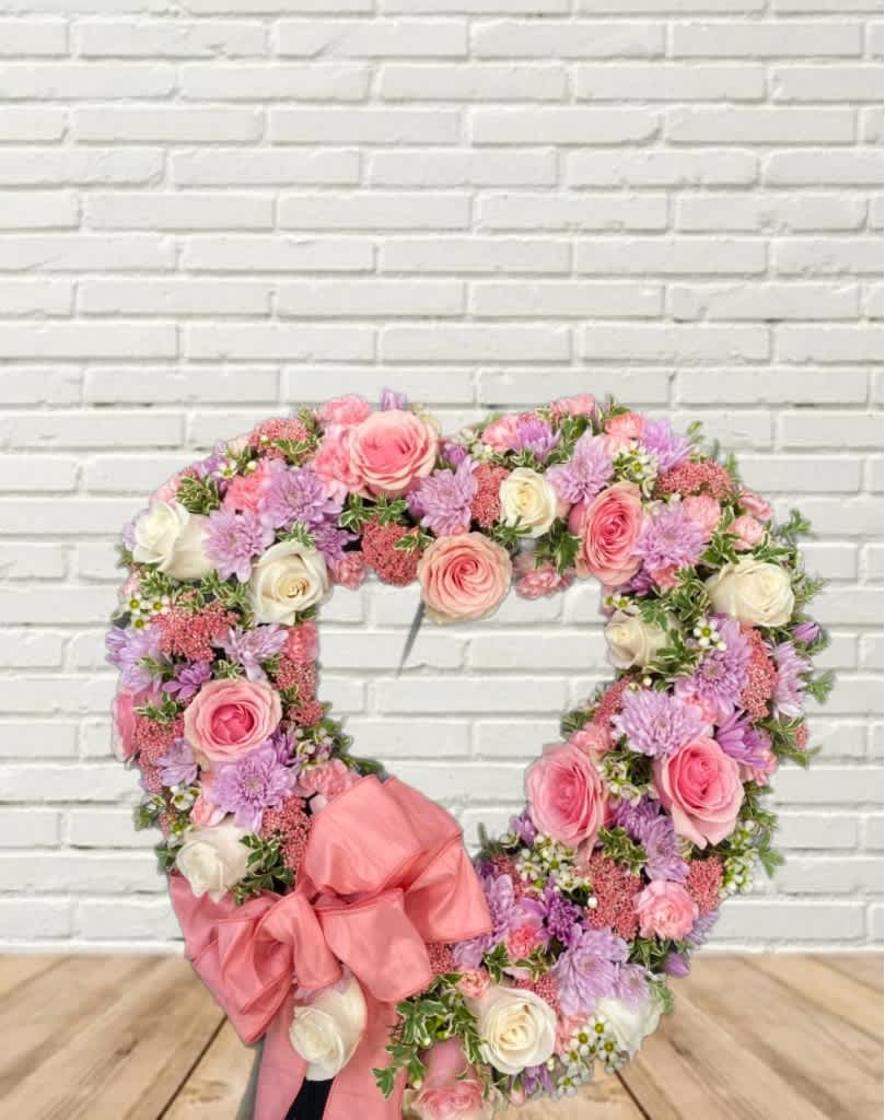 A 18&quot; open heart spray full of flowers, with a pink bow.
Names/